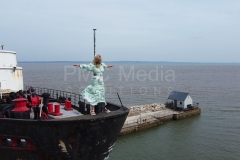 A woman standing on the bow of the Duke of Lancaster ship