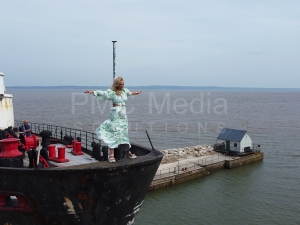 A woman standing on the bow of the Duke of Lancaster ship