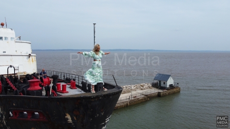 A woman standing on the bow of the Duke of Lancaster ship