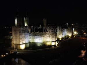 Caernarfon Castle lit up and from the air