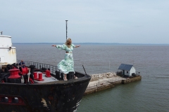 A woman standing on the bow of the Duke of Lancaster ship