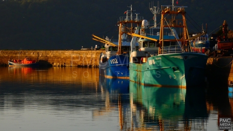 Porth Penrhyn ships at Golden Hour, with smooth glassy waters